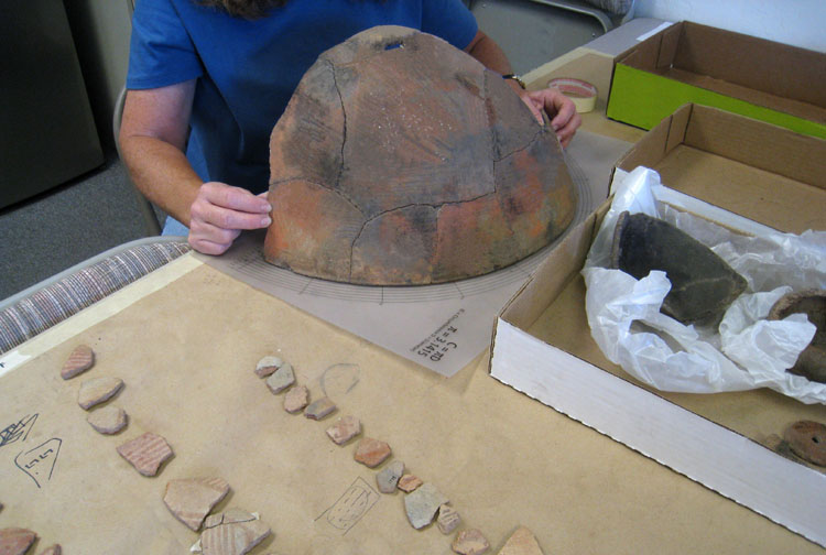 Broken vessel from a prehistoric pithouse dug by Desert Archaeology is reconstructed in the laboratory.