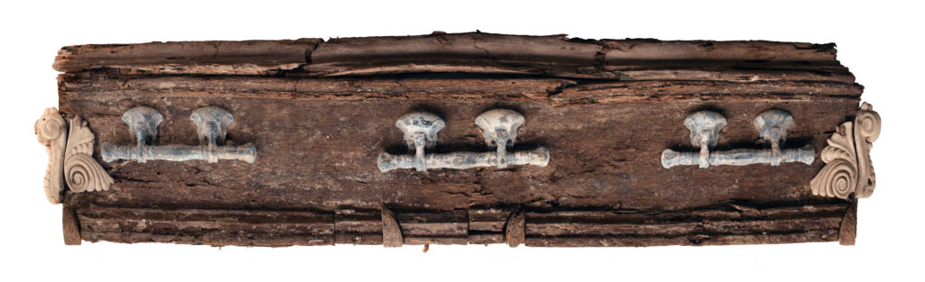 A well-preserved coffin, found by Desert Archaeology, with molded gutta percha griffins on each corner, wooden molding, and swing bail handles (photograph by Robert Ciaccio).