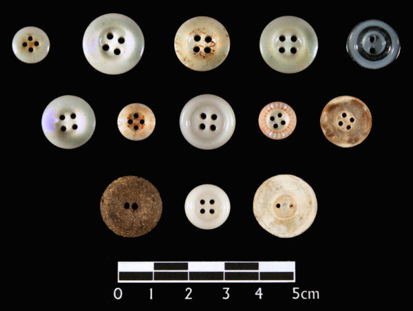 <em>Buttons from the garments inside the child's coffin. </em>