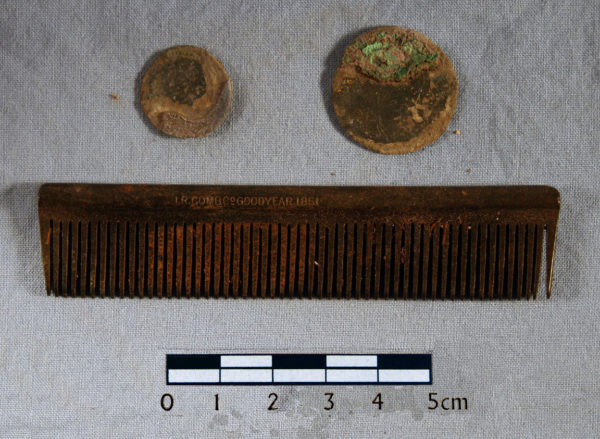 <em>A comb and two coins from the man's right pocket. </em>