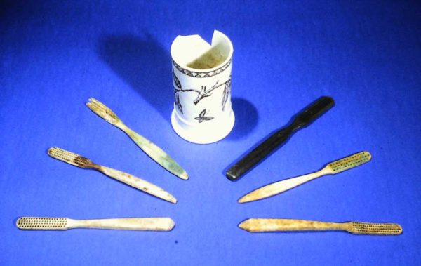 <em>Toothbrushes and a toothbrush holder from Block 73. In the 1920s, only about 25 percent of Americans regularly brushed their teeth (photo by Greg Berg).</em>