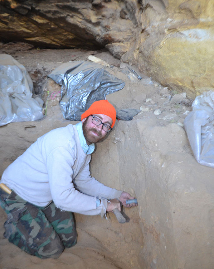 Caleb Ferbrache collecting OSL samples from a rockshelter in Montana. Here he is pounding a tube into the sediment for the equivalent dose sample.