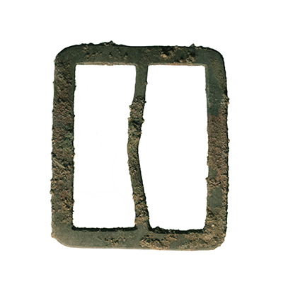 Photo of a corroded a British military uniform belt buckle.