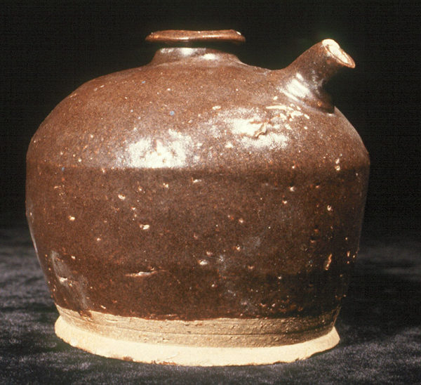Photo of a ceramic Chinese soy sauce jug. It is squat and round with a short spout and a small lipped opening on top.