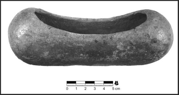 Photo of an elongated plain ware vessel. It looks like a hot dog bun, or a dugout canoe with rounded ends.